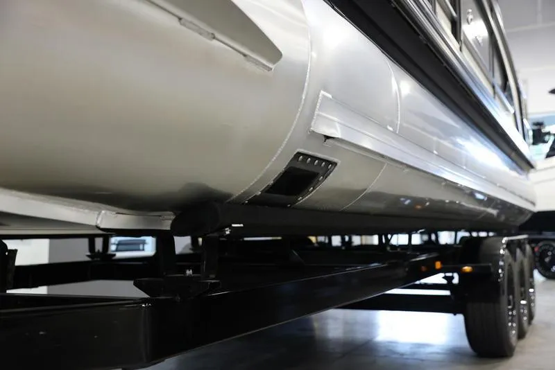 Slide: The Image of 2024 Barletta LUSSO L25M pontoon boat on a trailer, close-up view. - 7