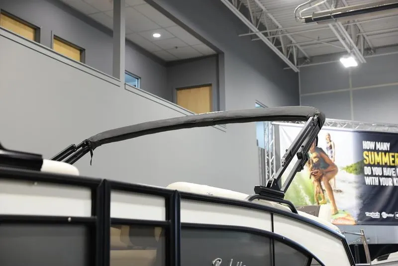 Slide: The Image of 2024 Barletta LUSSO L25M pontoon boat in showroom, side view. - 8