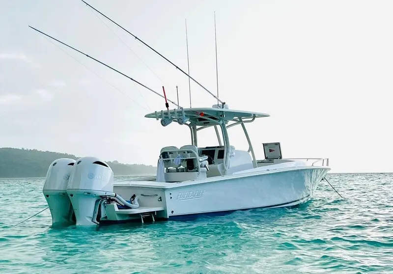 The Image of 2017 Jupiter 32 Cuddy Cabin boat on clear turquoise water. - 0
