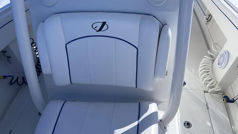 Slide: The Image of 2017 Jupiter 32 Cuddy Cabin boat seat with logo, white upholstery. - 11
