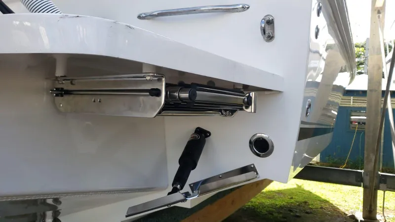 Slide: The Image of Close-up of 2017 Jupiter 32 Cuddy Cabin boat's trim tab and hydraulic system. - 13