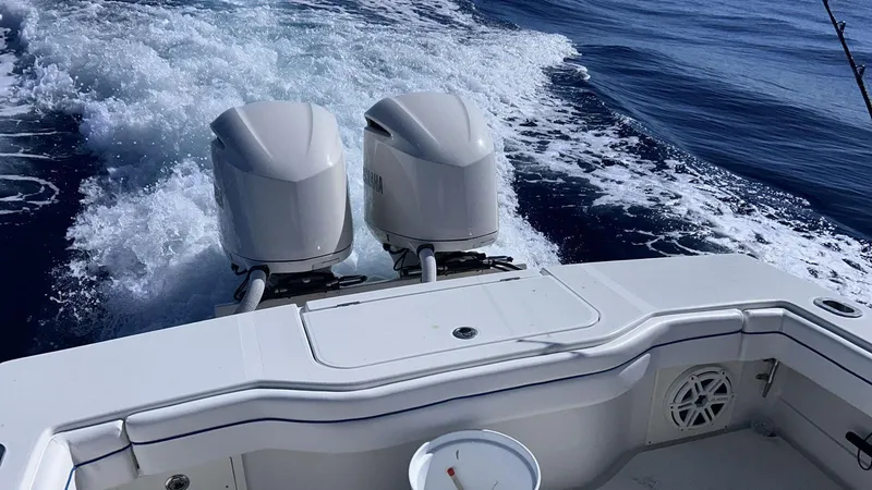 Slide: The Image of 2017 Jupiter 32 Cuddy Cabin boat with twin outboard engines on the open sea. - 14