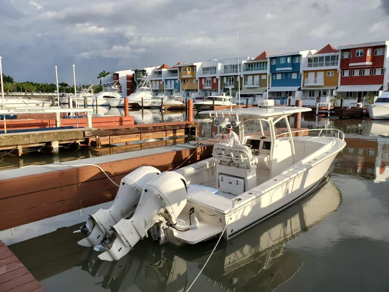 Slide: The Image of 2017 Jupiter 32 Cuddy Cabin boat docked in a colorful marina. - 4