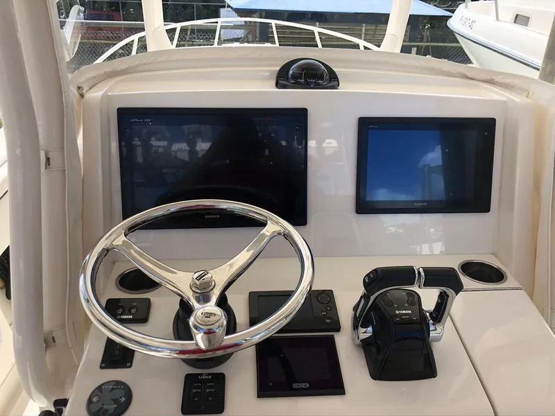 Slide: The Image of 2017 Jupiter 32 Cuddy Cabin boat helm with dual screens and controls. - 7