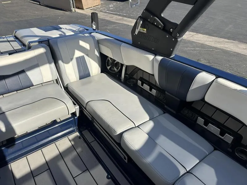 Slide: The Image of 2024 Malibu 23 MXZ boat interior with gray and white seating. - 10