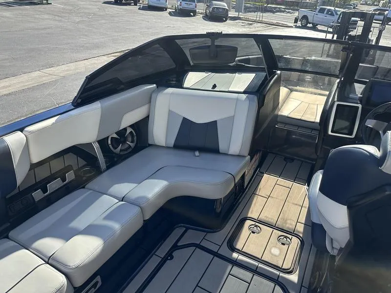 Slide: The Image of 2024 Malibu 23 MXZ boat interior with luxurious seating and modern design. - 15