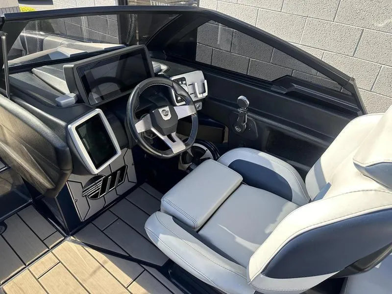 Slide: The Image of 2024 Malibu 23 MXZ boat interior with modern dashboard and steering wheel. - 17