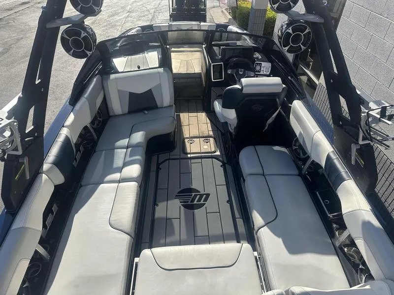 Slide: The Image of 2024 Malibu 23 MXZ boat interior with spacious seating and advanced audio system. - 18