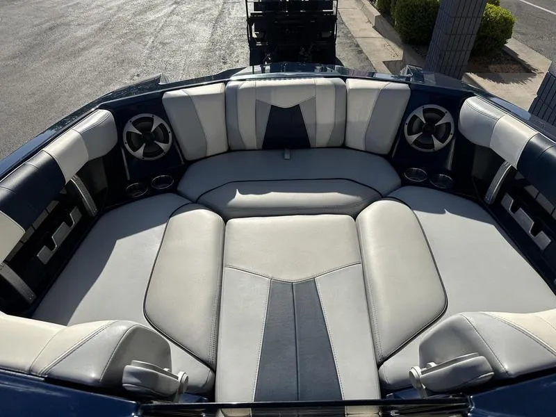 Slide: The Image of 2024 Malibu 23 MXZ boat interior with luxurious seating and built-in speakers. - 20