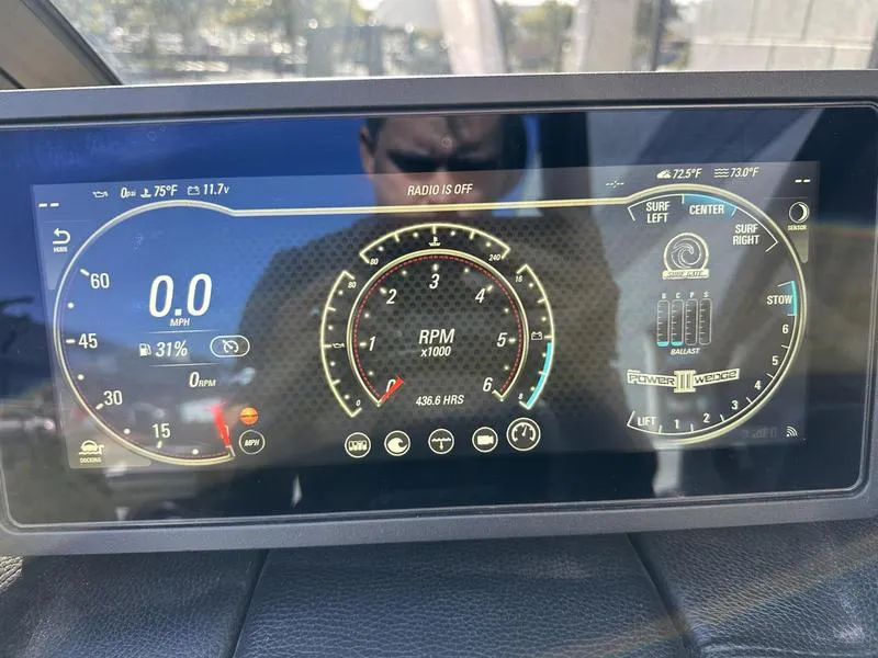 Slide: The Image of 2024 Malibu 23 MXZ dashboard display showing speed, RPM, and various controls. - 6