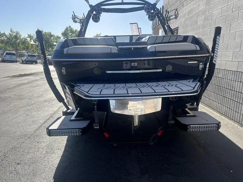 Slide: The Image of 2024 Malibu 23 MXZ boat rear view in a parking lot. - 9