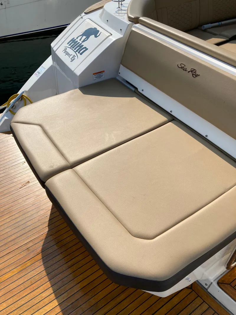 Slide: The Image of 2020 Sea Ray 320 Sundancer boat with tan seating and teak deck. - 11