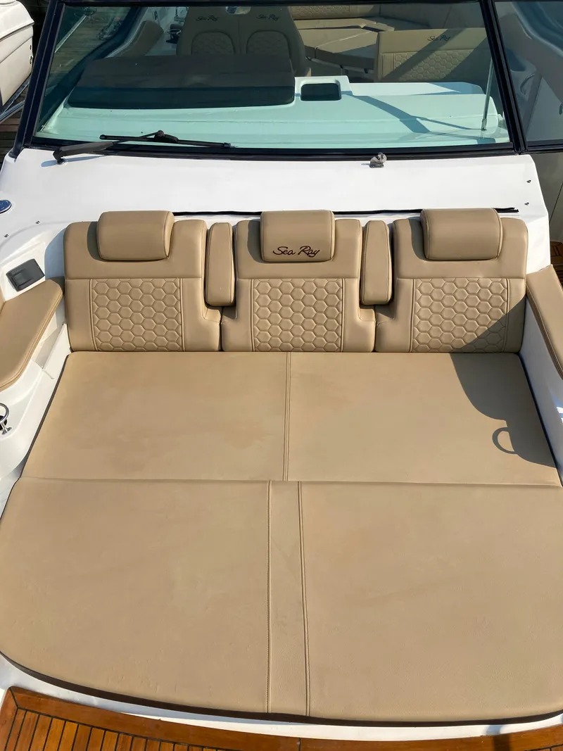 Slide: The Image of 2020 Sea Ray 320 Sundancer boat with beige leather seating and elegant design. - 23