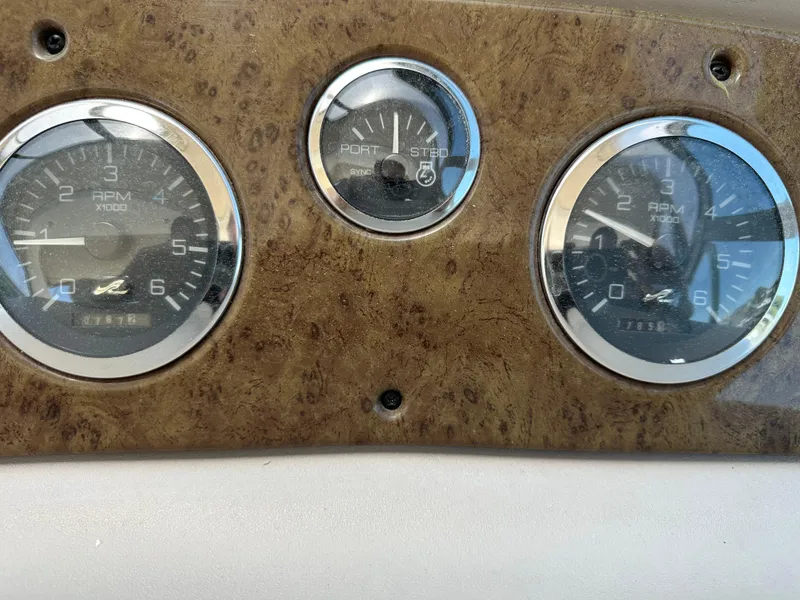 Slide: The Image of Dashboard gauges of a 1999 Sea Ray 310 Sundancer boat. - 13