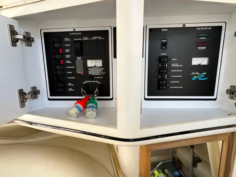 Slide: The Image of Electrical panel of a 1999 Sea Ray 310 Sundancer boat with open cabinet doors. - 18