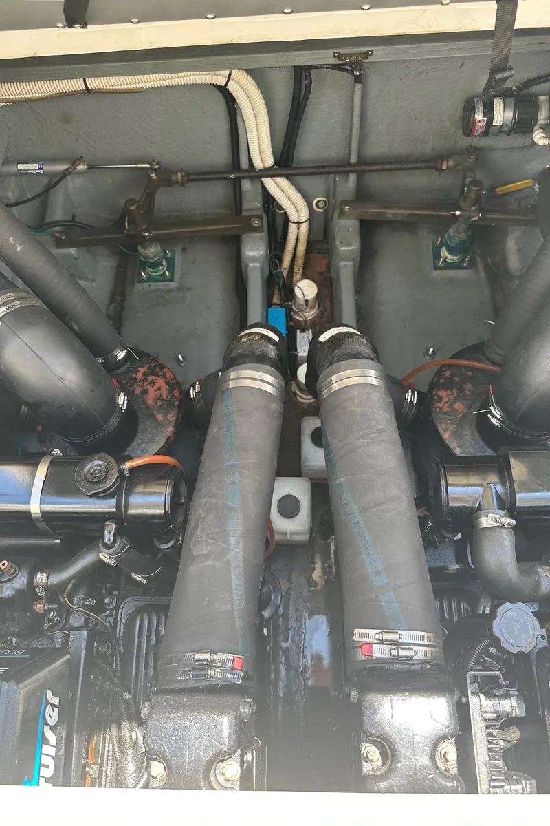 Slide: The Image of Engine compartment of a 1999 Sea Ray 310 Sundancer boat, showing dual engines and components. - 27