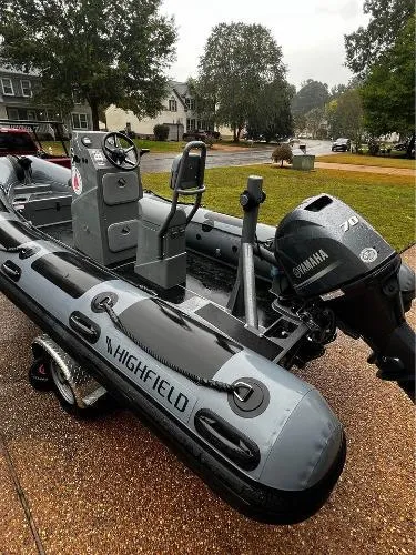Slide: The Image of 2025 Highfield Patrol 500 boat with Yamaha engine on a trailer, parked outdoors. - 2