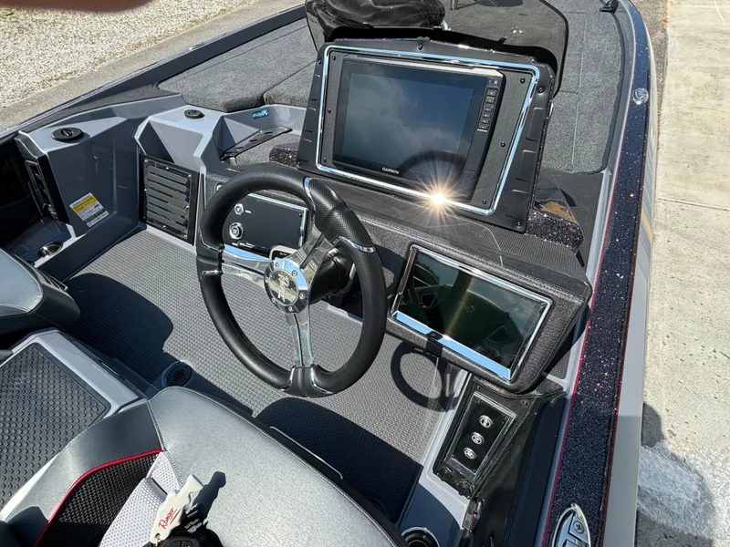 Slide: The Image of 2025 Ranger Z521R boat dashboard with advanced navigation systems and steering wheel. - 10