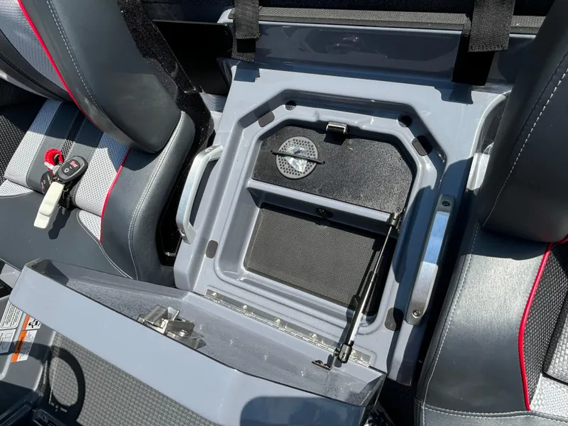 Slide: The Image of 2025 Ranger Z521R boat storage compartment with open lid and key fob. - 11