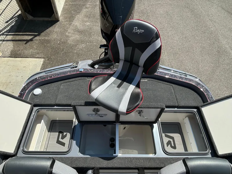 Slide: The Image of 2025 Ranger Z521R boat with open storage compartments and a central seat. - 13