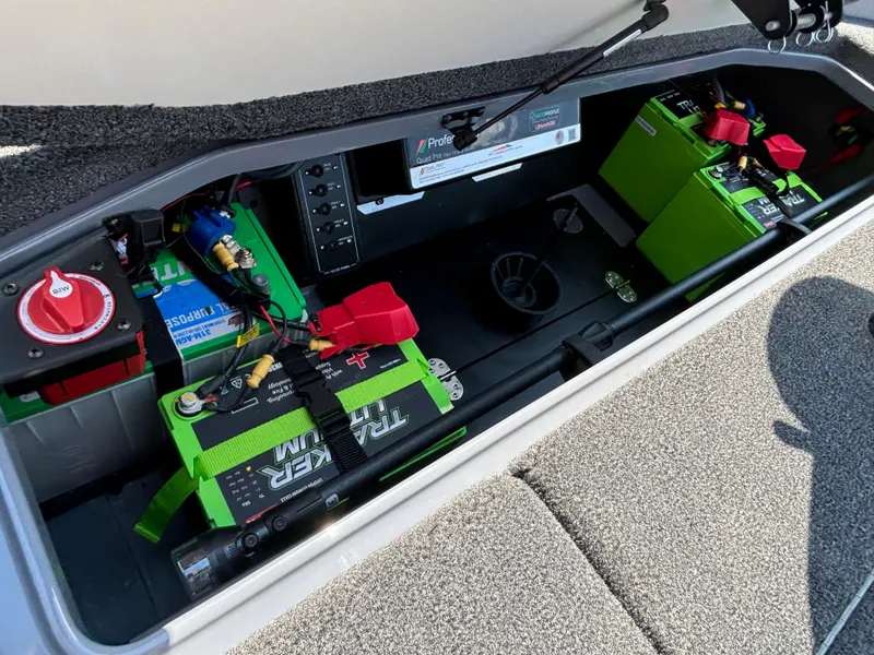 Slide: The Image of 2025 Ranger Z521R boat battery compartment with green lithium batteries and wiring. - 14
