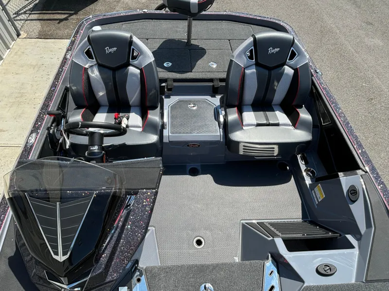 Slide: The Image of 2025 Ranger Z521R boat interior with dual seats and steering console. - 9