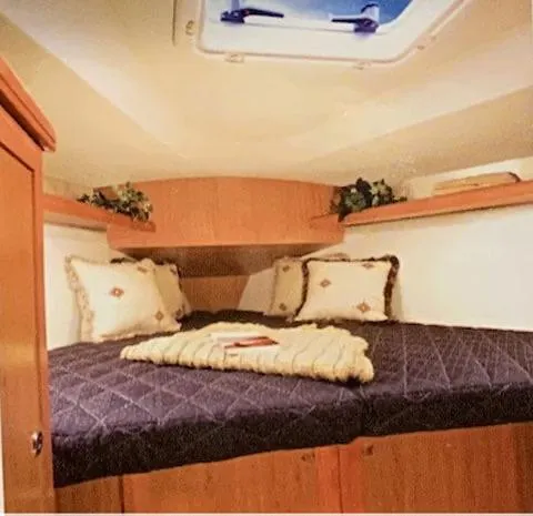 Slide: The Image of Cozy cabin bedroom in a 2009 Hunter 36 sailboat with skylight and decorative pillows. - 10