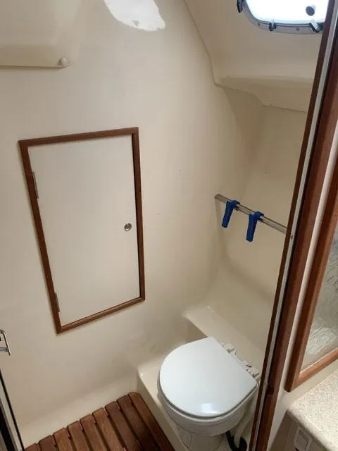 Slide: The Image of 2009 Hunter 36 sailboat bathroom with toilet and storage cabinet. - 11