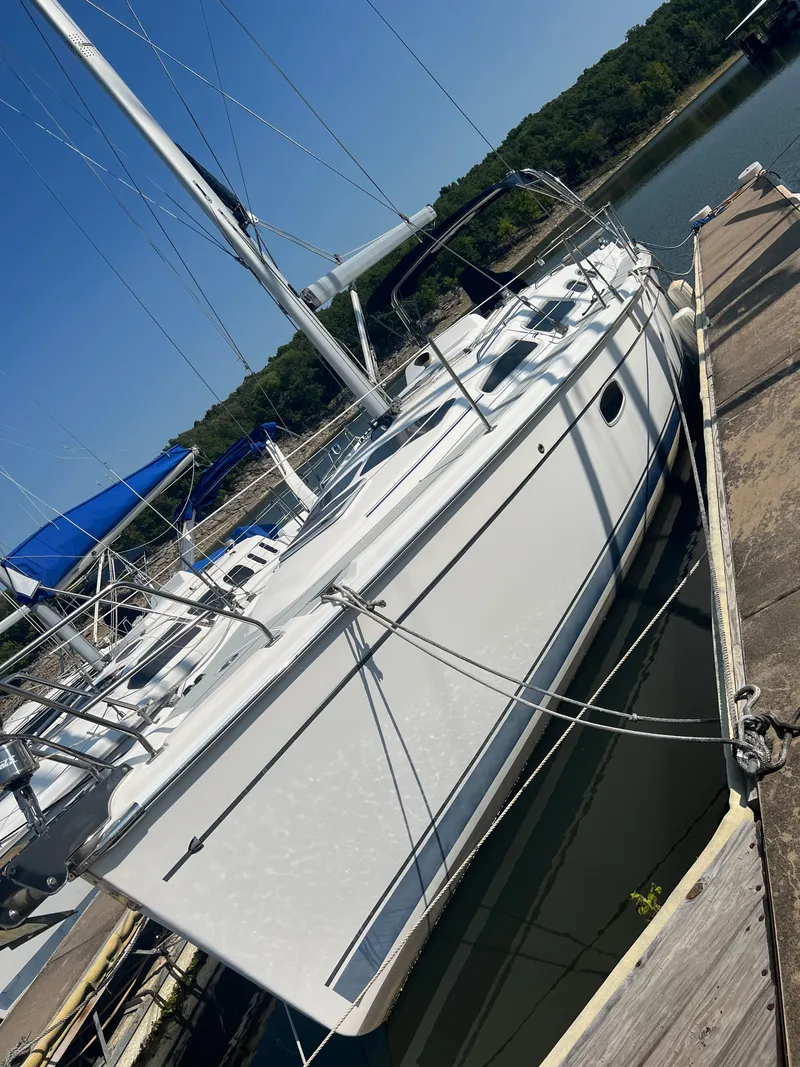 Slide: The Image of 2009 Hunter 36 sailboat docked at a marina on a sunny day. - 6