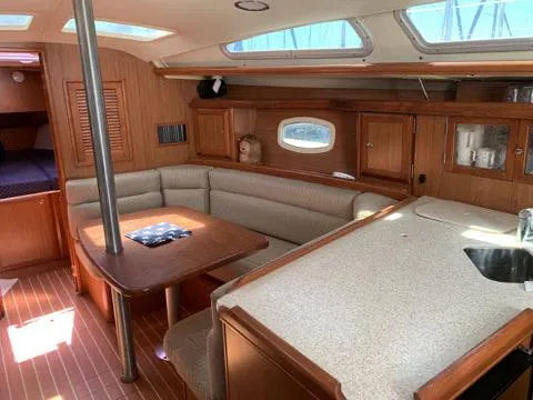 Slide: The Image of Interior of a 2009 Hunter 36 sailboat with dining area and kitchenette. - 7