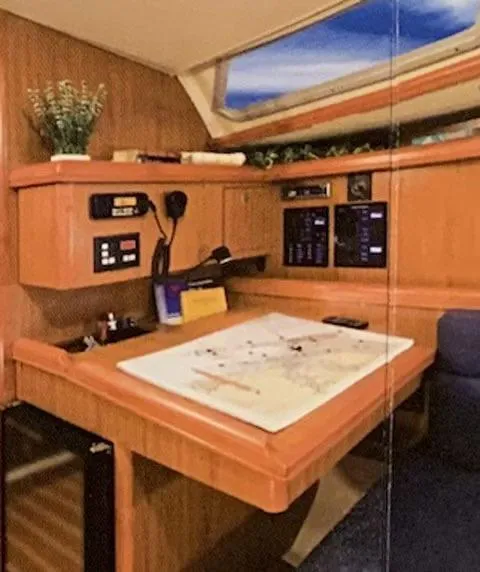 Slide: The Image of Navigation station inside a 2009 Hunter 36 sailboat with chart table and control panels. - 8