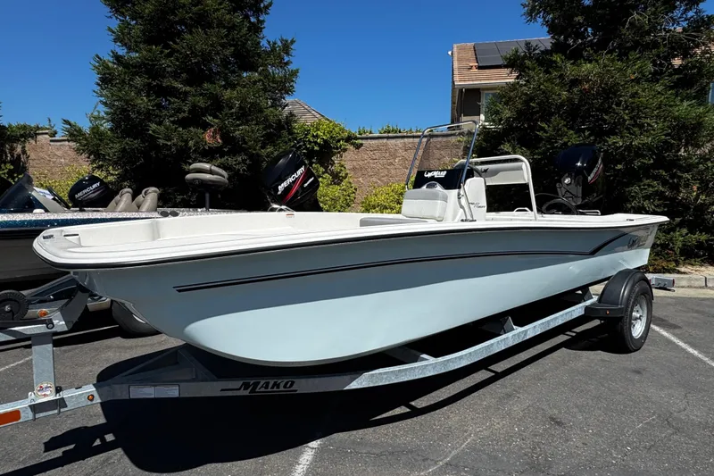 Slide: The Image of 2024 Mako Pro Skiff 17 CC boat on trailer, parked outdoors. - 2