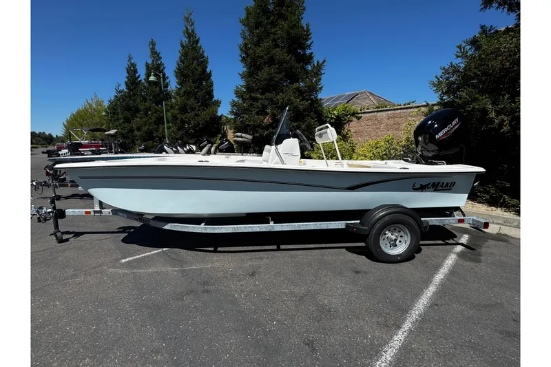 Slide: The Image of 2024 Mako Pro Skiff 17 CC boat on trailer, parked outdoors. - 7