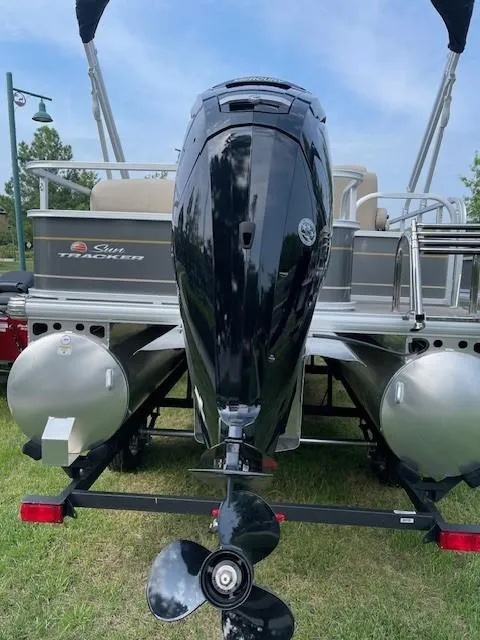 Slide: The Image of 2024 Sun Tracker Party Barge 18 DLX pontoon boat with outboard motor. - 2