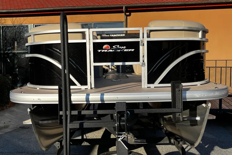 Slide: The Image of 2024 Sun Tracker Sportfish 24 XP3 pontoon boat on trailer, front view. - 2