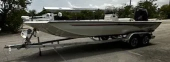 The Image of 2024 Ranger RB210 boat on a trailer in a parking lot. - 0
