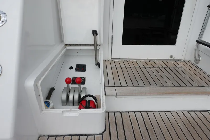 Slide: The Image of 1988 Donzi Z-65 Tournament Fisherman boat controls on teak deck, featuring throttle levers and gauges. - 11