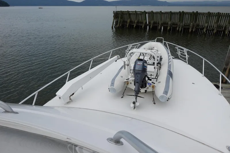 Slide: The Image of 1988 Donzi Z-65 Tournament Fisherman yacht with dinghy on deck, docked by wooden pier. - 15