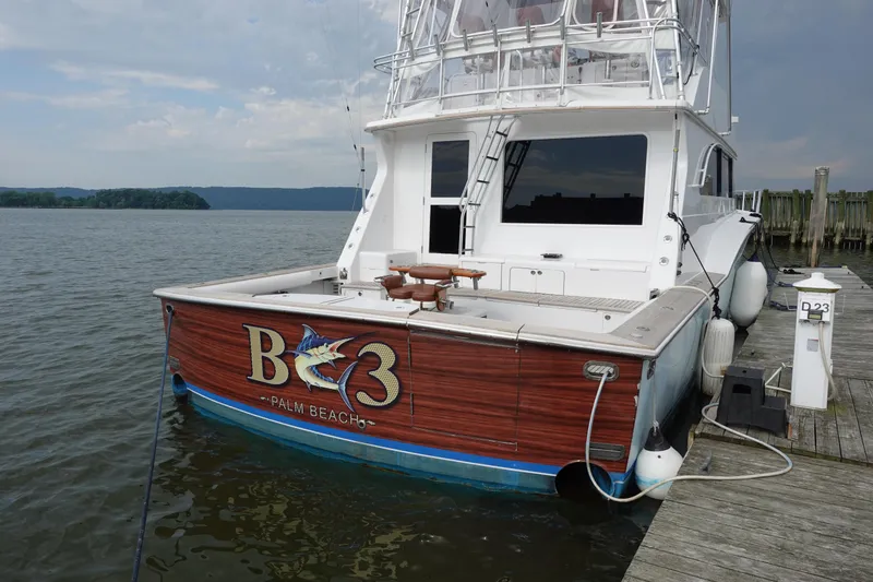 Slide: The Image of 1988 Donzi Z-65 Tournament Fisherman docked, featuring wooden accents and fishing equipment. - 2