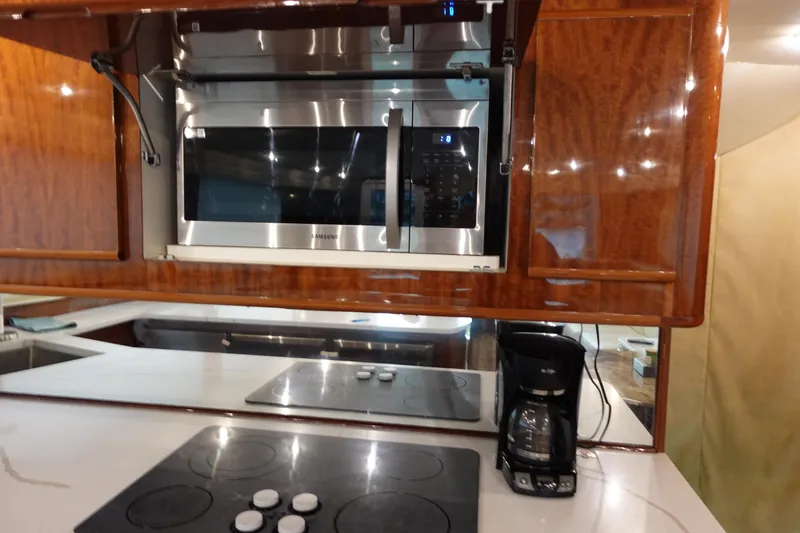 Slide: The Image of Kitchen area of 1988 Donzi Z-65 Tournament Fisherman with microwave, stovetop, and coffee maker. - 28