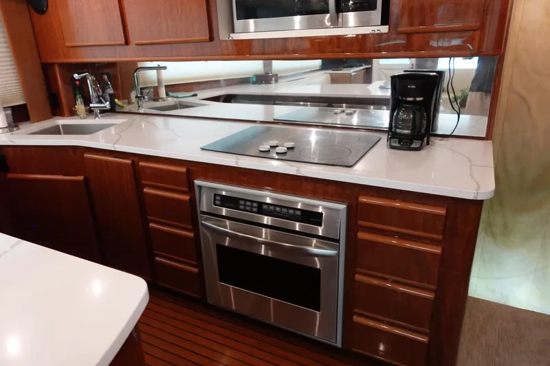 Slide: The Image of 1988 Donzi Z-65 Tournament Fisherman yacht kitchen with modern appliances and wooden cabinetry. - 29