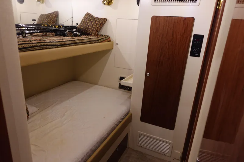 Slide: The Image of 1988 Donzi Z-65 Tournament Fisherman cabin with bunk beds and wood paneling. - 40