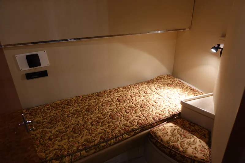 Slide: The Image of 1988 Donzi Z-65 Tournament Fisherman cabin with patterned bedding and cozy lighting. - 44