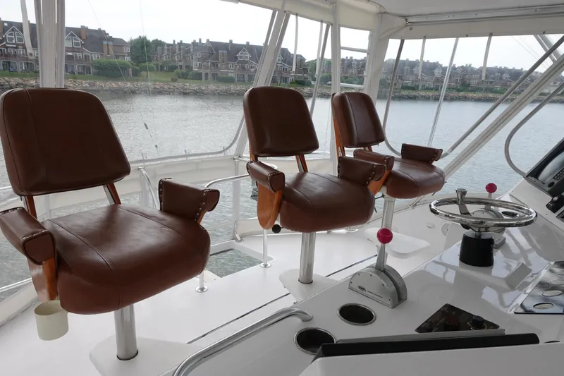 Slide: The Image of 1988 Donzi Z-65 Tournament Fisherman helm with three brown leather chairs and control panel. - 46