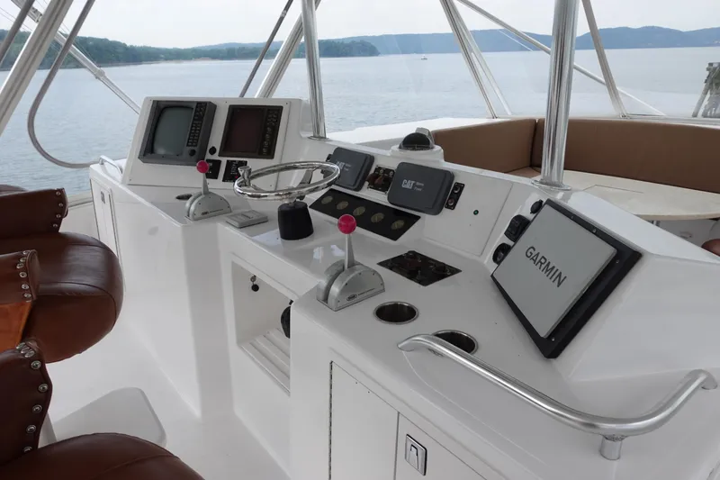 Slide: The Image of 1988 Donzi Z-65 Tournament Fisherman helm with Garmin navigation, leather seats, and scenic water view. - 47