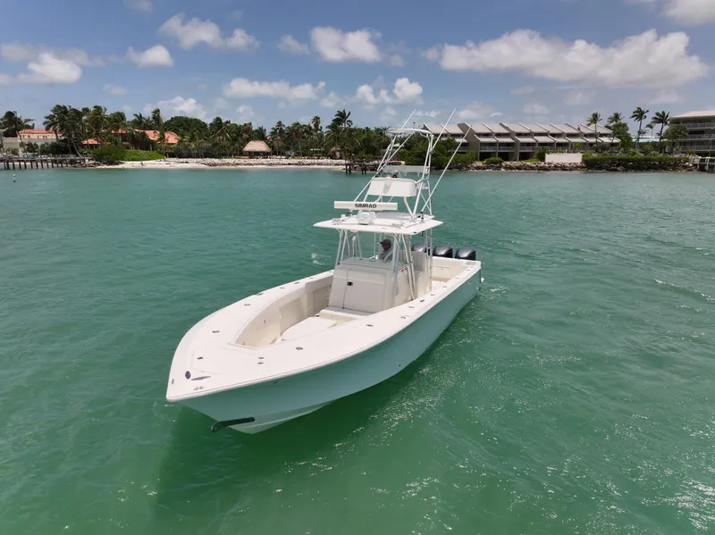 Slide: The Image of 2015 SeaVee 370z boat on turquoise water near a tropical shoreline. - 13