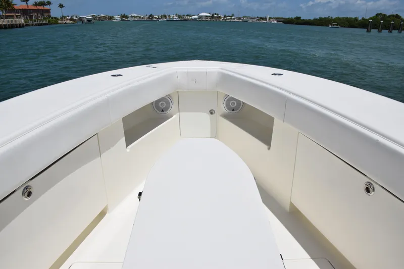 Slide: The Image of 2015 SeaVee 370z boat bow with seating and storage compartments on calm water. - 18