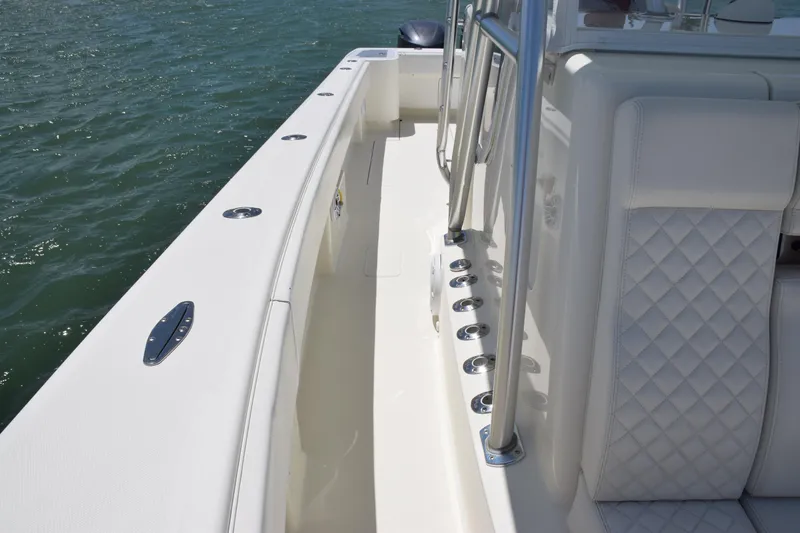 Slide: The Image of 2015 SeaVee 370z boat deck with rod holders and cushioned seating. - 21
