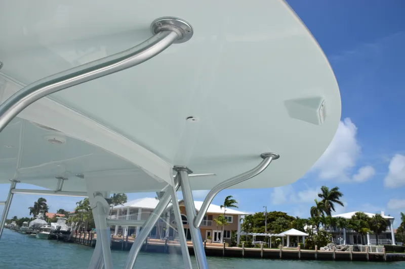 Slide: The Image of 2015 SeaVee 370z boat with T-top, docked near waterfront homes. - 22
