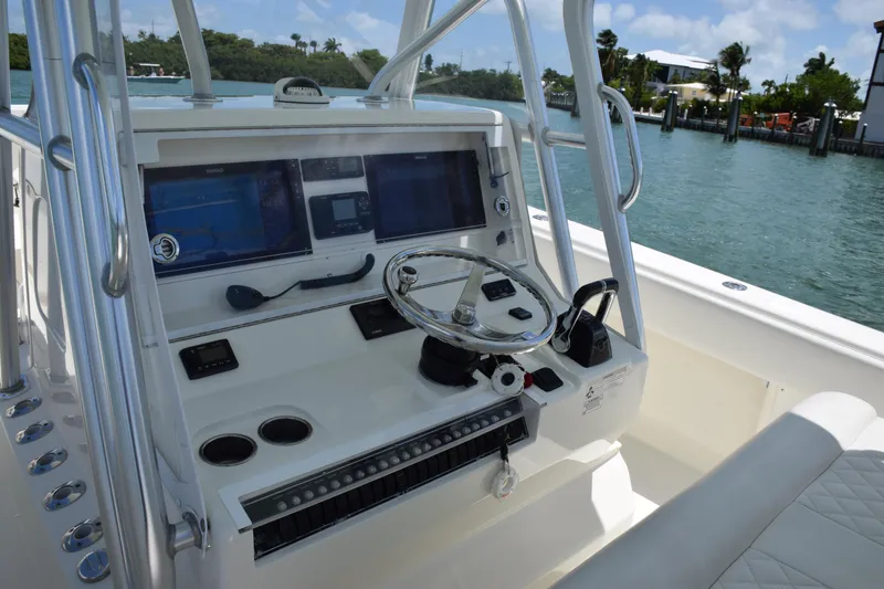 Slide: The Image of 2015 SeaVee 370z boat helm with dual screens and steering wheel. - 24